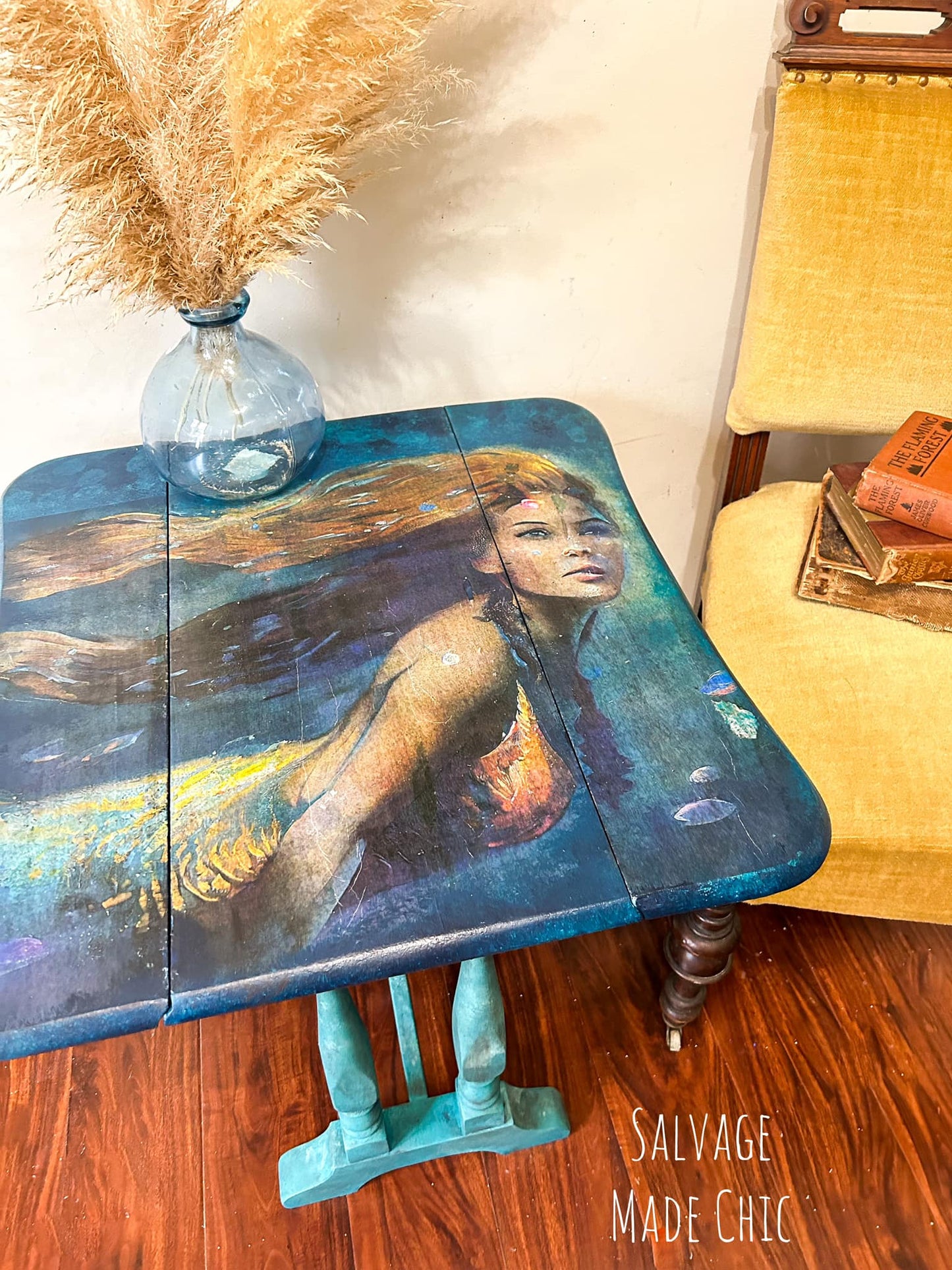 Close-up of vibrant mermaid design featuring shimmering teal and purple paper fibers, showcasing textured surface detail.