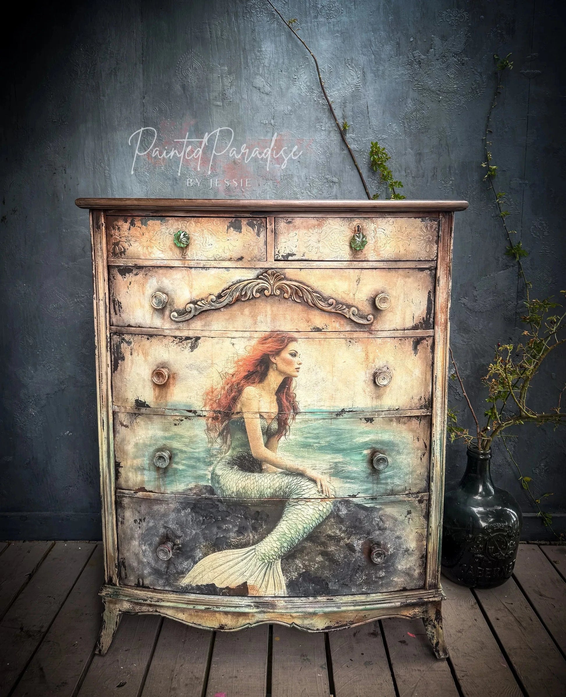 Close-up of the crinkled, semi-transparent tissue paper with intricate sea-inspired patterns in shades of blue and beige.