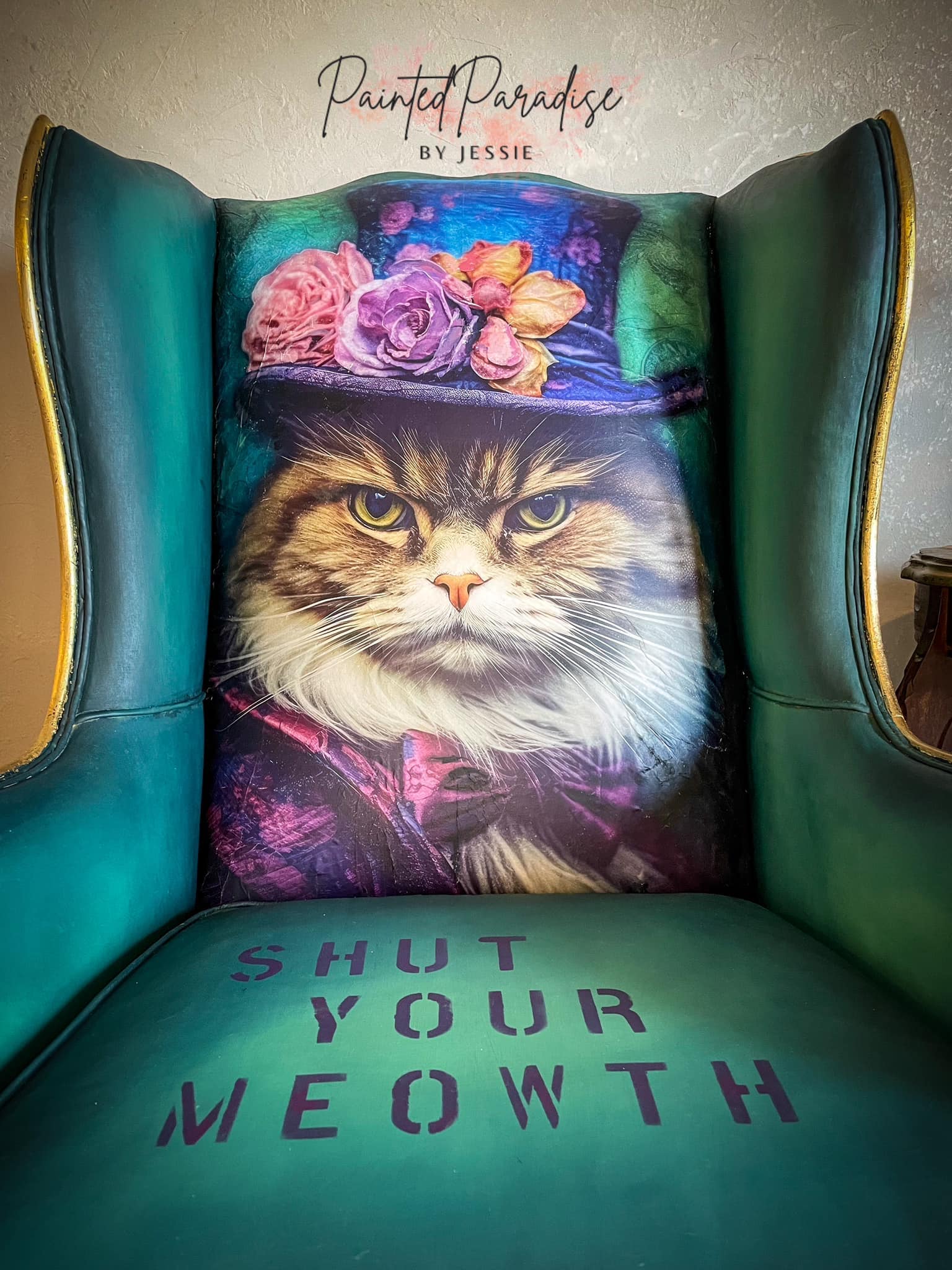 Close-up of wingback chair with Sour Puss on the bakc and Shut your meowth on the seat.